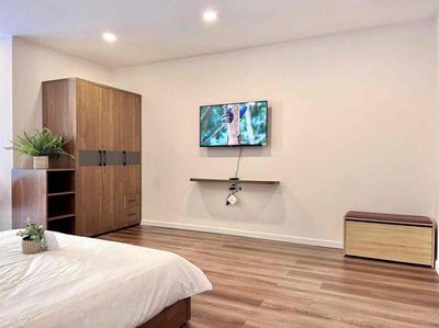 The balcony studio apartment is full of furniture away from the kitchen at the center of District 7