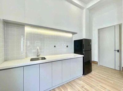 The apartment is full of furniture near the airline to District 10