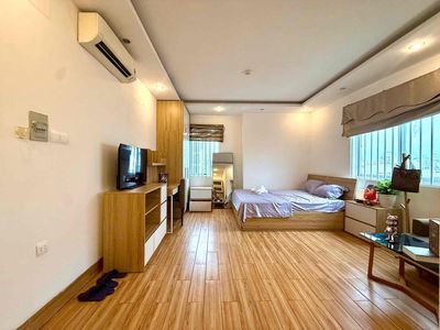 mini kitchen apartments away from bed with open windows, elevators.