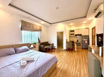 mini kitchen apartments away from bed with open windows, elevators.