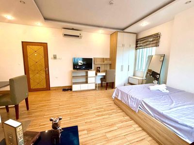 mini kitchen apartments away from bed with open windows, elevators.