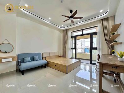 The studio of a large bedroom has soft furniture.