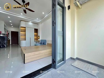 The studio of a large bedroom has soft furniture.