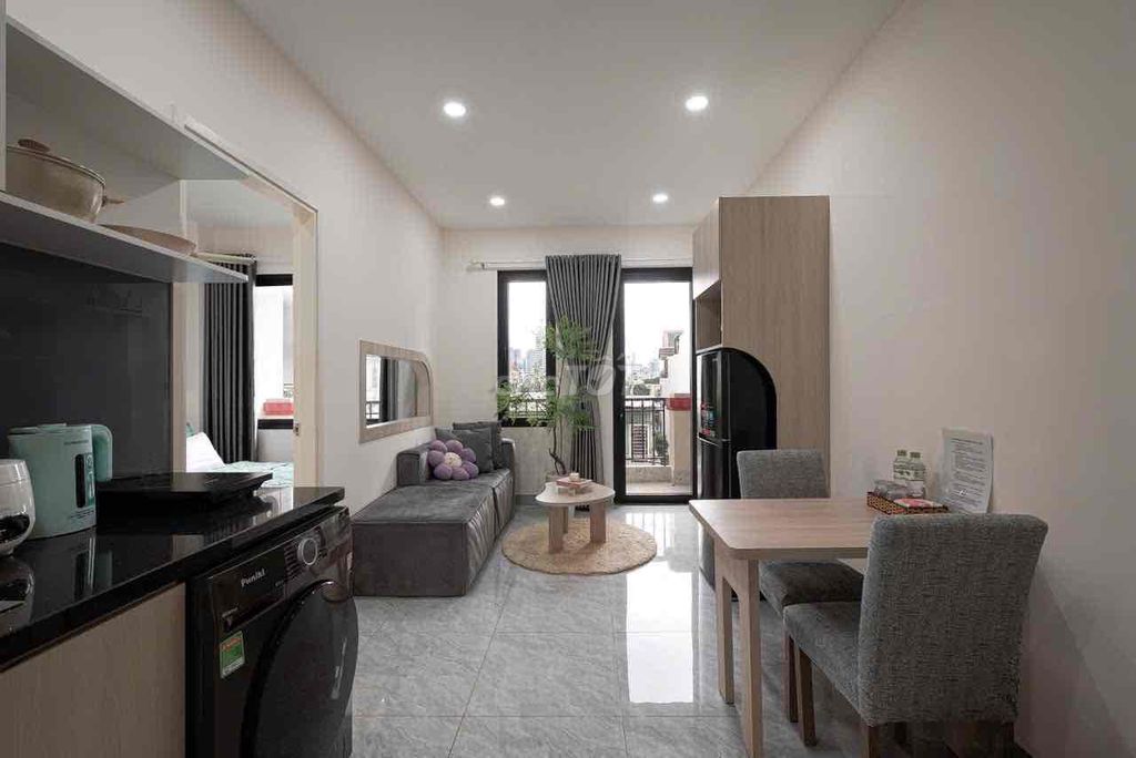 A mini apartment. A ballony bedroom. A wide open window.