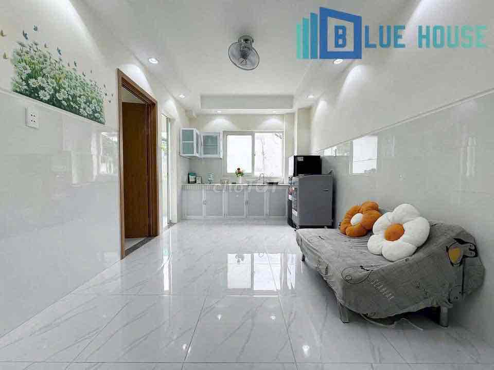 Two brand-new apartment bedrooms in a full-house bathroom with windows on it.
