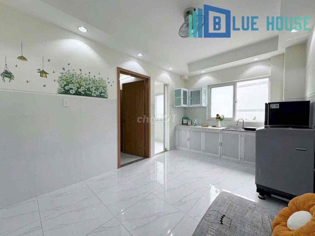 Two brand-new apartment bedrooms in a full-house bathroom with windows on it.