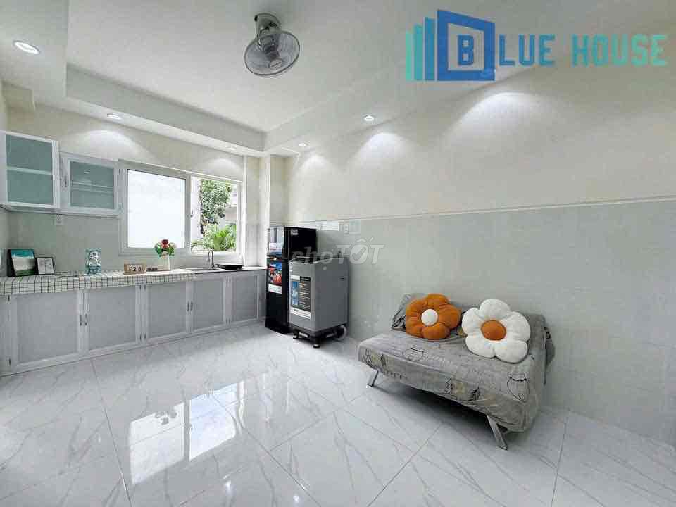 Two brand-new apartment bedrooms in a full-house bathroom with windows on it.