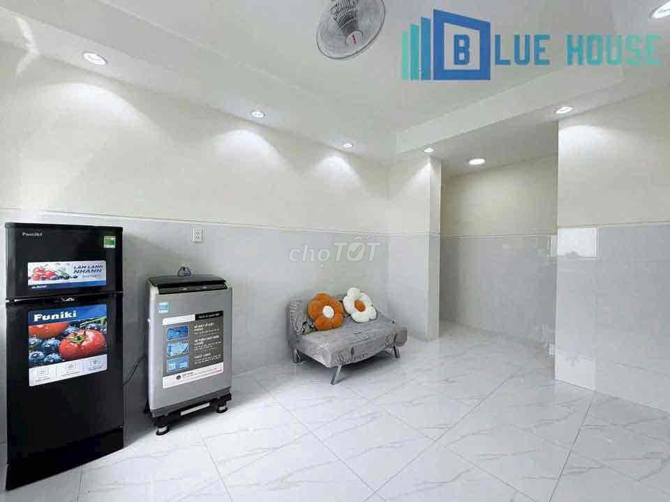 Two brand-new apartment bedrooms in a full-house bathroom with windows on it.