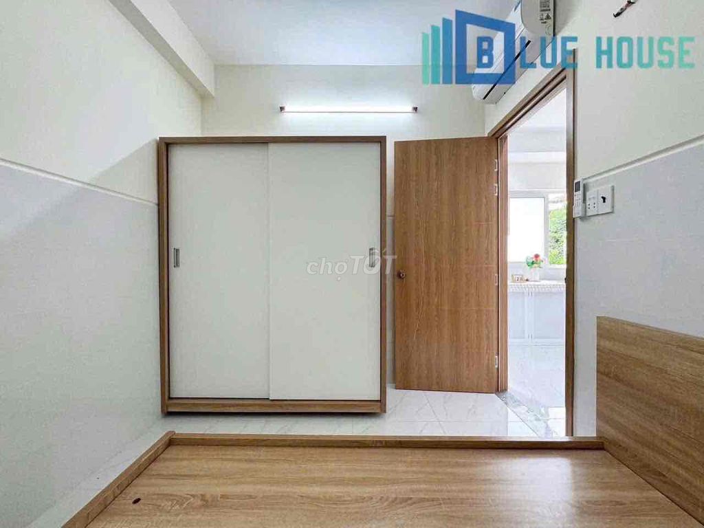 Two brand-new apartment bedrooms in a full-house bathroom with windows on it.
