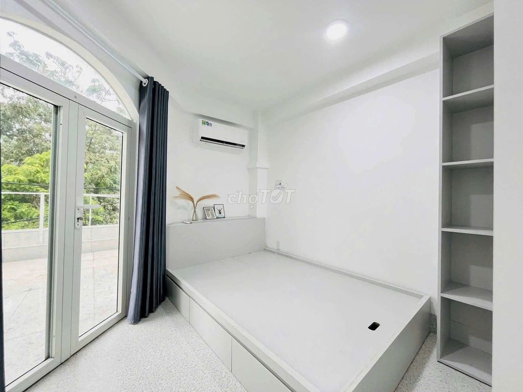 The apartment is full of furniture. The front door is right on the Tries.