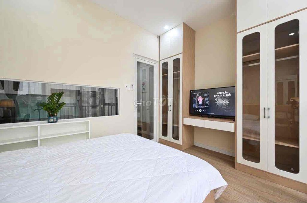 A super-spotty kitchen service apartment. An empty bedroom.