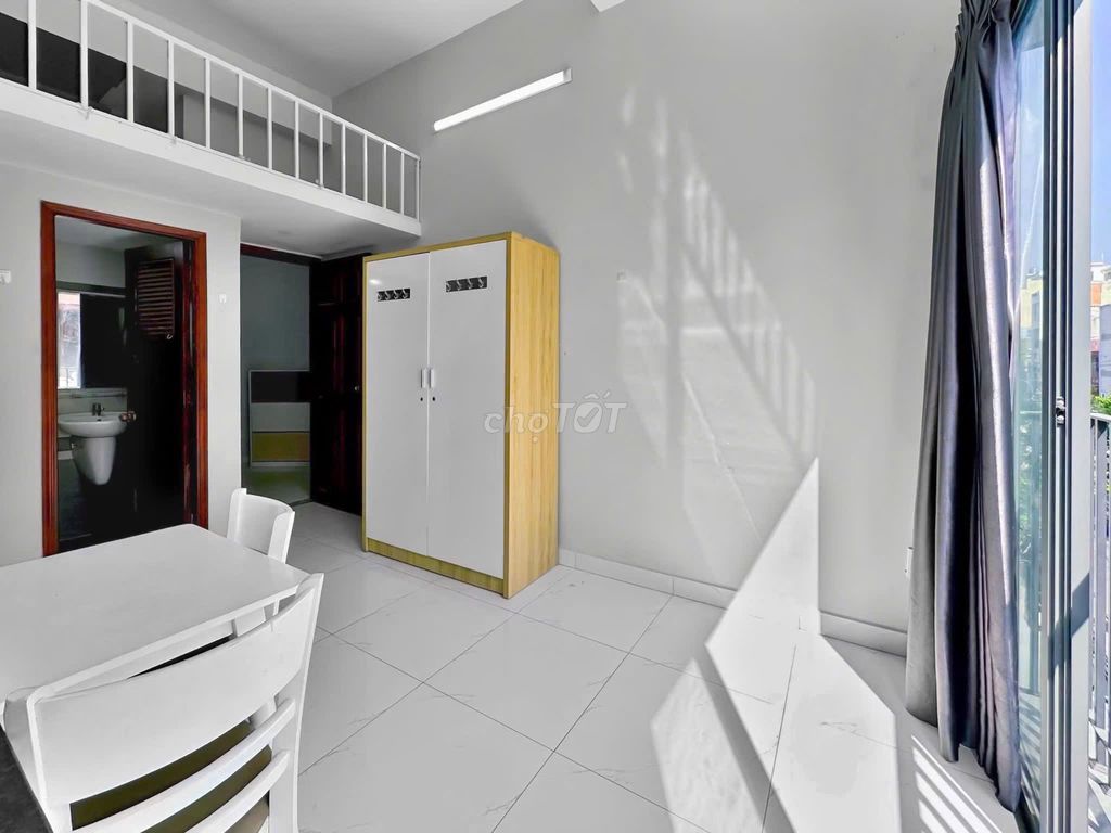 The mini apartment has a balcony. The bedroom is against District 1 3-house security.