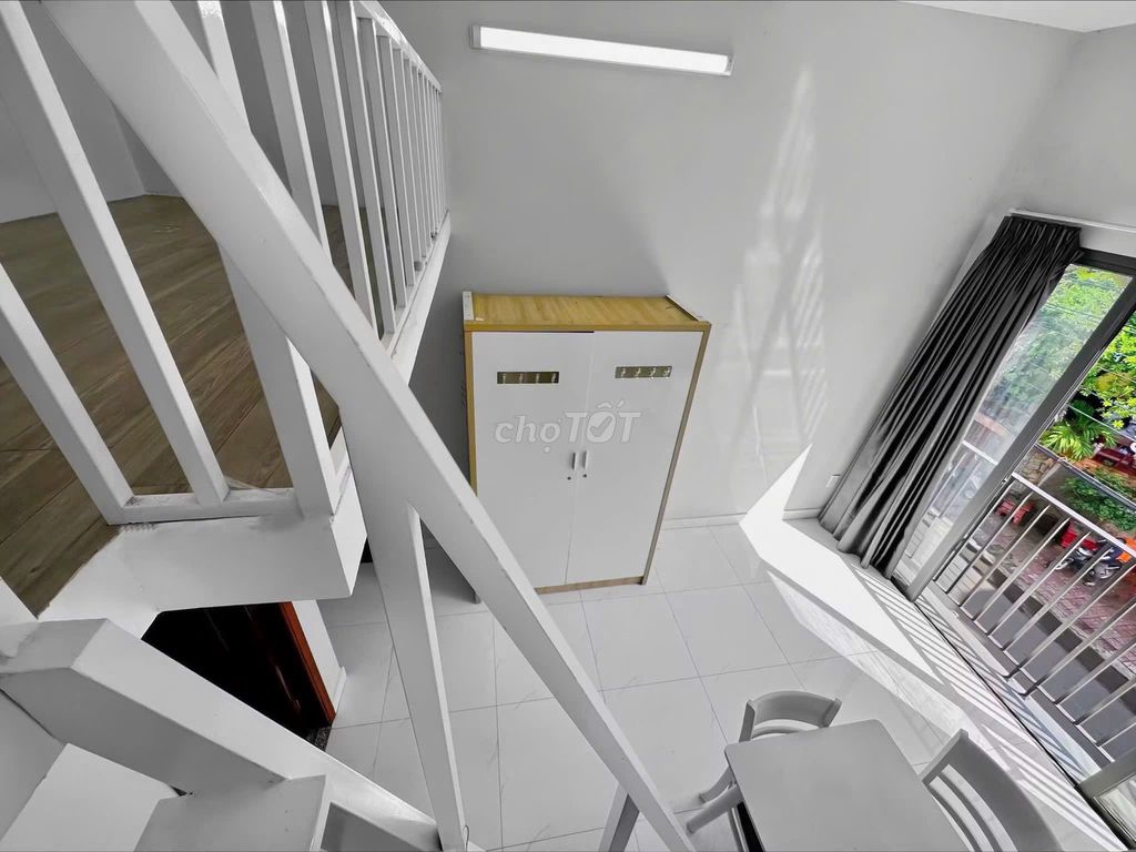 The mini apartment has a balcony. The bedroom is against District 1 3-house security.