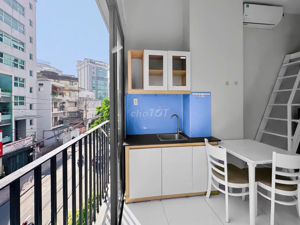 The mini apartment has a balcony. The bedroom is against District 1 3-house security.