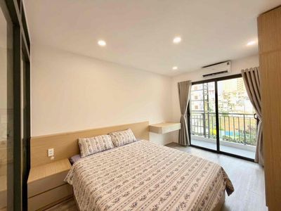 The apartment is a balcony bedroom full of furniture right near Saigon Bridge.
