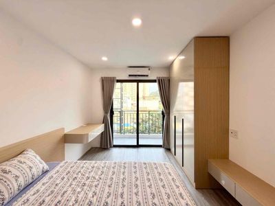 The apartment is a balcony bedroom full of furniture right near Saigon Bridge.