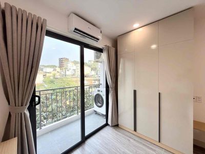 The apartment is a balcony bedroom full of furniture right near Saigon Bridge.