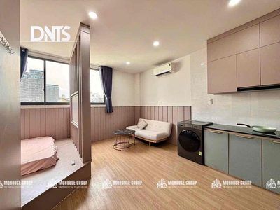 The elevator kitchen studio has a super-looking washing machine.