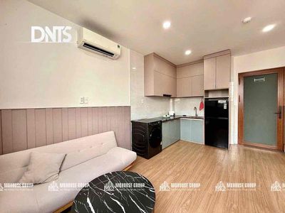 The elevator kitchen studio has a super-looking washing machine.