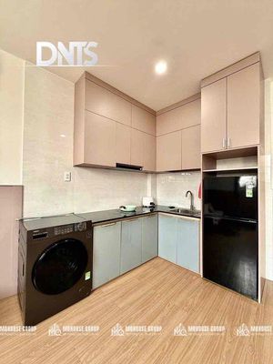 The elevator kitchen studio has a super-looking washing machine.