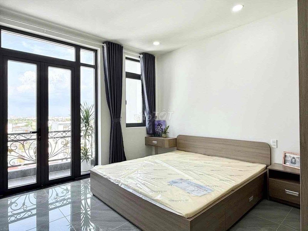 A bedroom-a full interior balcony.