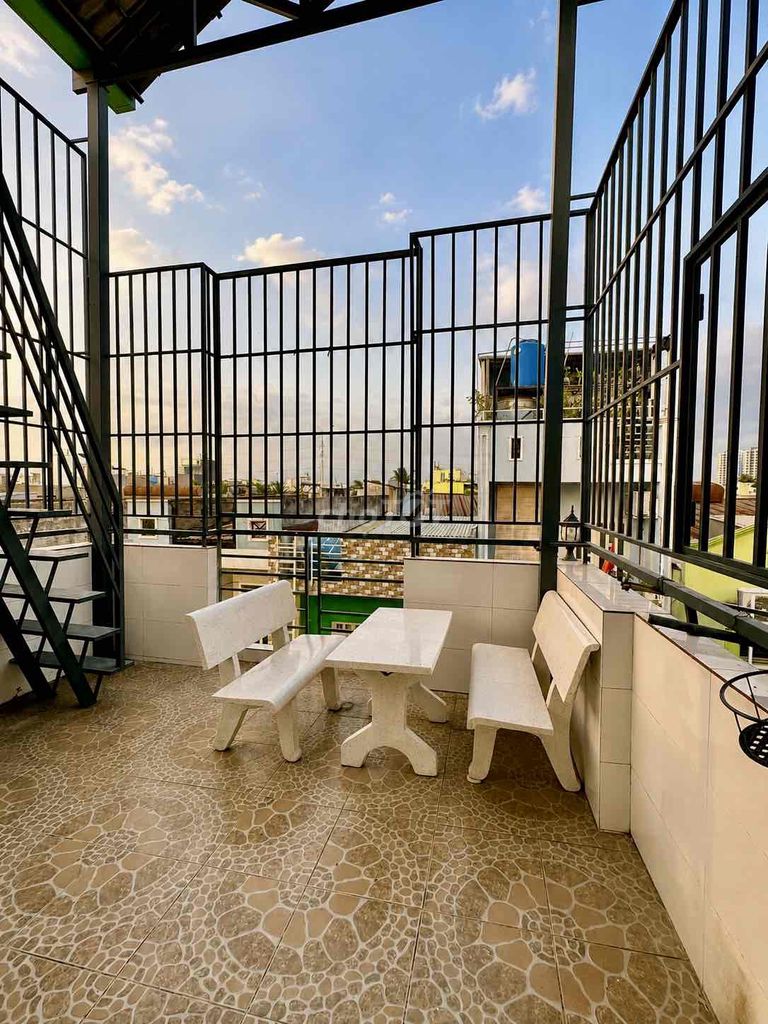 The entire second floor has a broad balcony with a roof.