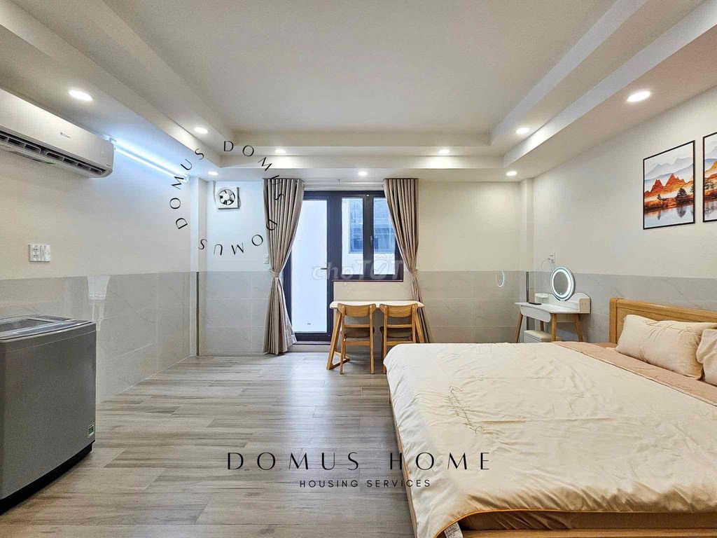 The studio apartment is full of furniture, open wide windows in the heart of District 7