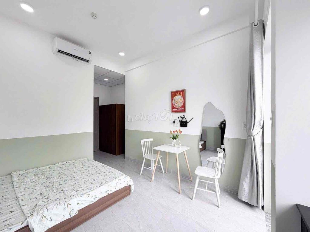 The new studio, open windows, basic interior -- one room available.