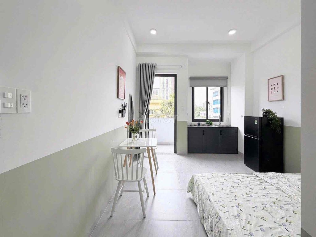 The new studio, open windows, basic interior -- one room available.