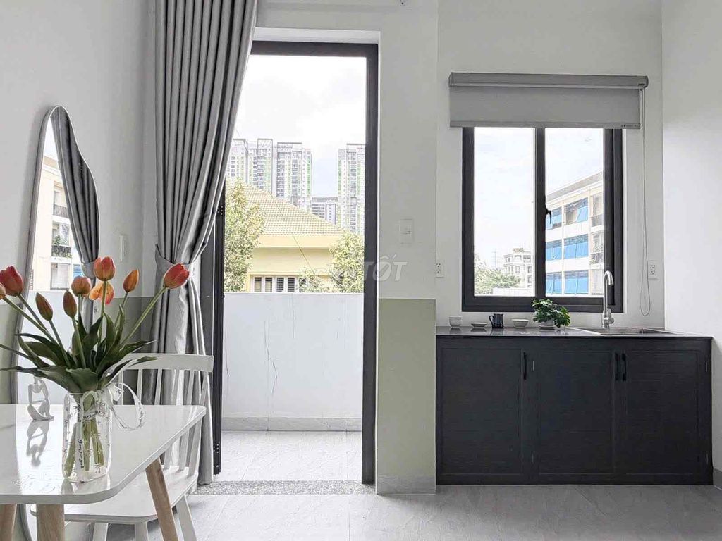 The new studio, open windows, basic interior -- one room available.