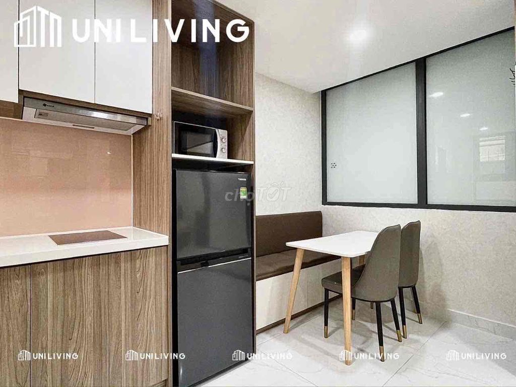 The studio's studio split kitchen full of furniture bordering its own marketing
