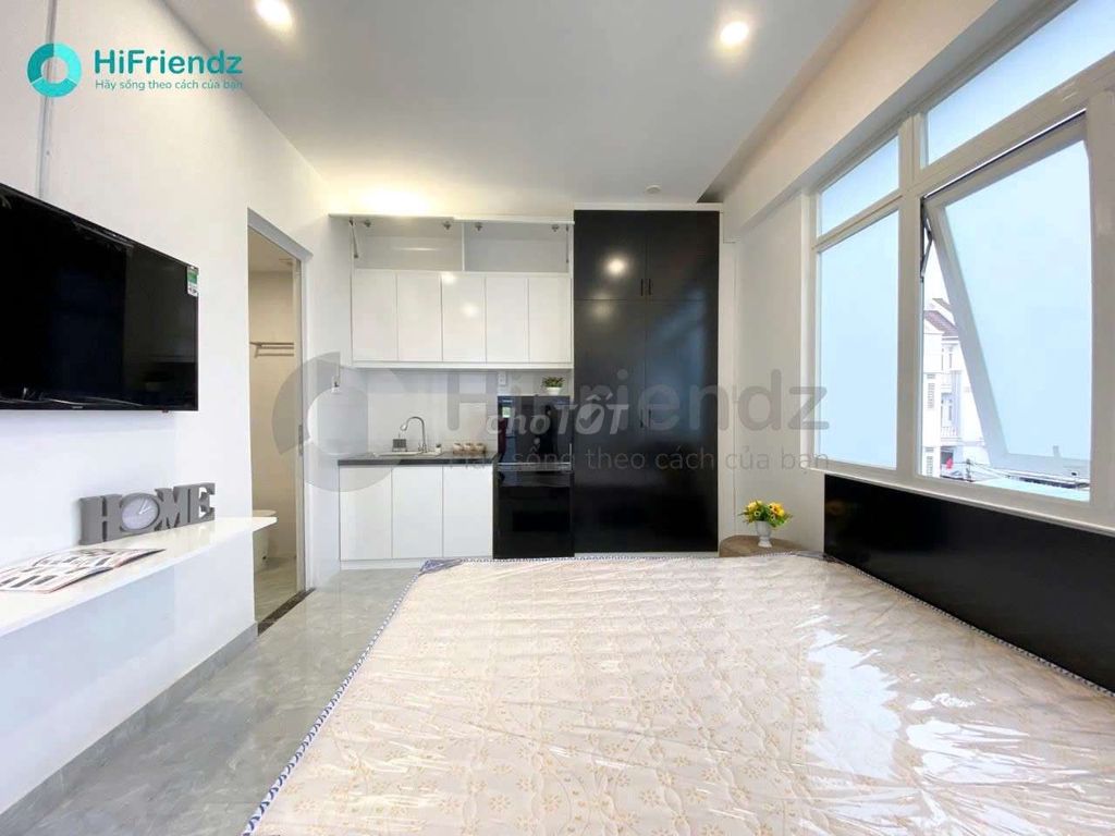The studio is full of furniture, and the room is open with a balcony.
