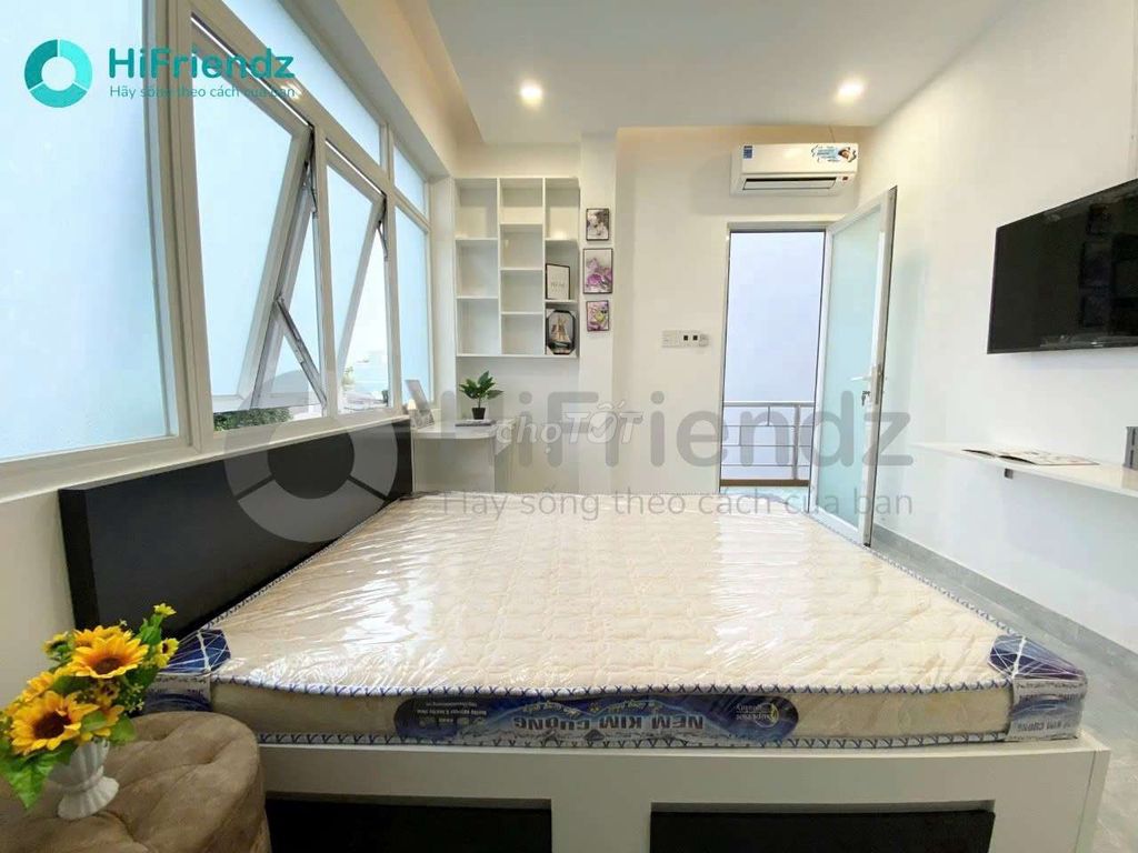 The studio is full of furniture, and the room is open with a balcony.