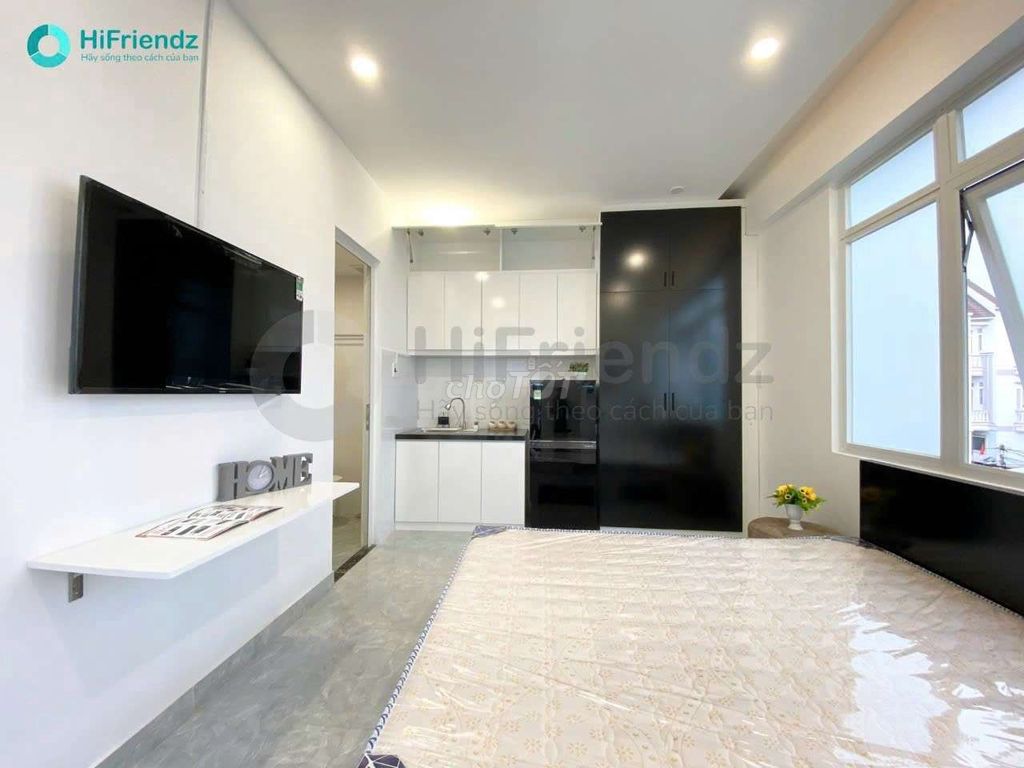 The studio is full of furniture, and the room is open with a balcony.