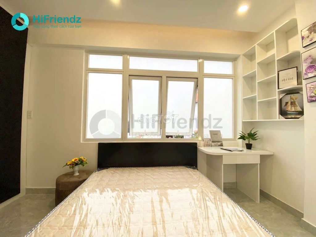 The studio is full of furniture, and the room is open with a balcony.