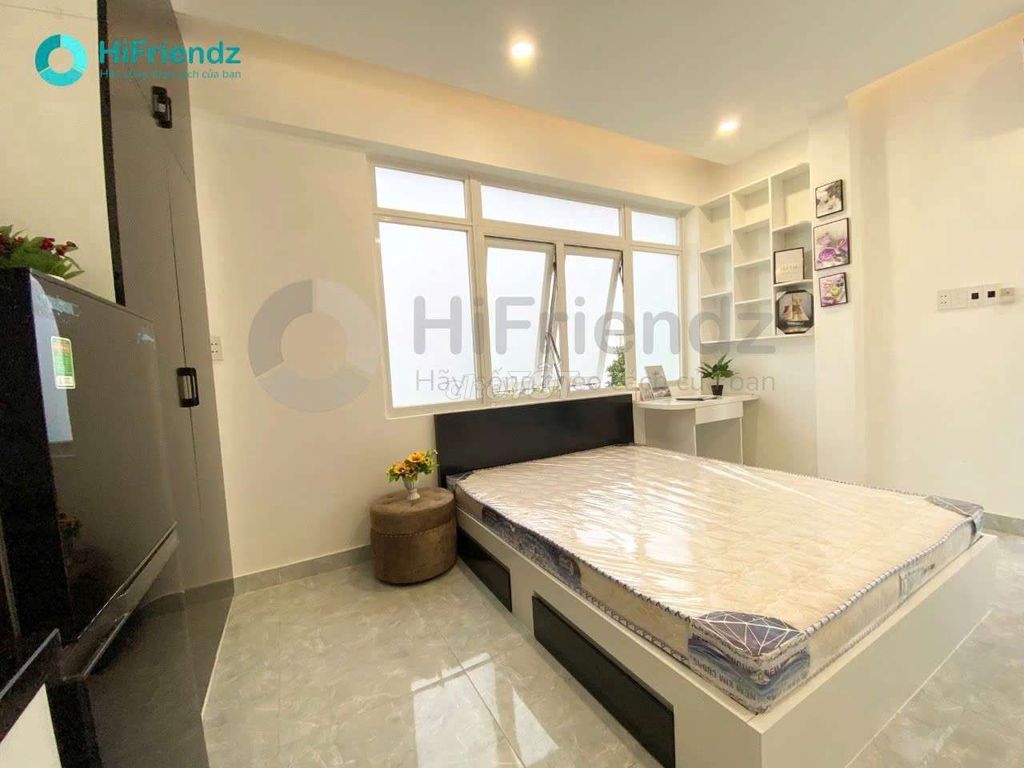 The studio is full of furniture, and the room is open with a balcony.