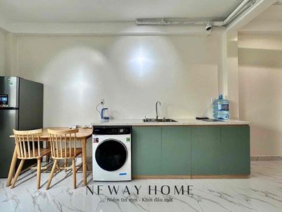 The big, cool window house is full of furniture with a new home washing machine.