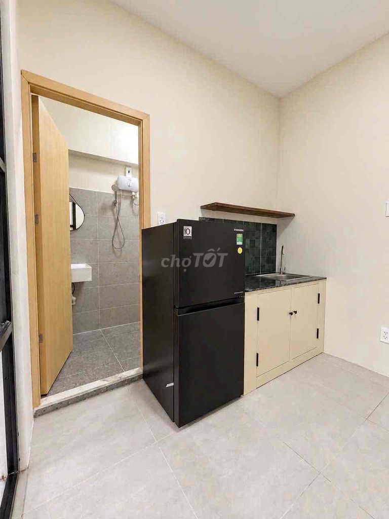 A new kitchen is open in a balcony bedroom.