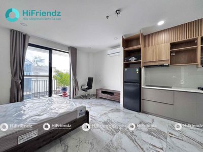 The studio is full of furniture - a super open balcony at the center of District 2.
