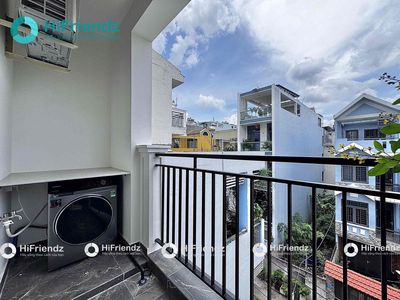 The studio is full of furniture - a super open balcony at the center of District 2.