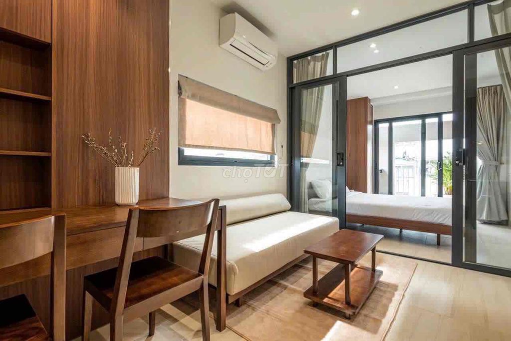 A large balcony bedroom full of furniture