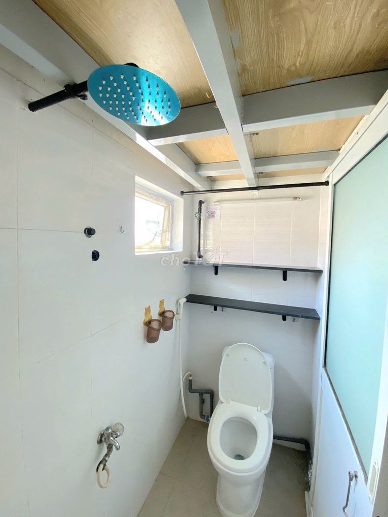 The motel has air conditioning near the shower.